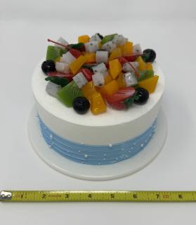 A small cake topped with fruit