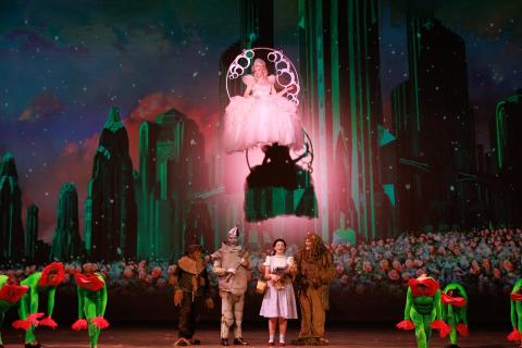 A woman in a pink dress floating in a bubble