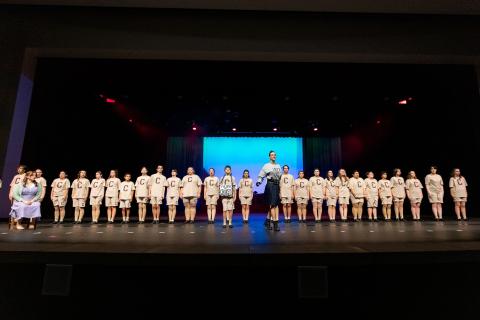 Cast is lined up for gym inspection by Ms. Trunchbull