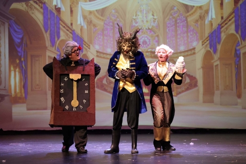 Photo Credit: Wetumpka High School A trio of performers in front of a castle interior digital projection