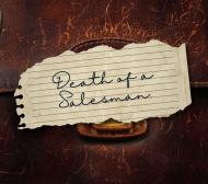 death of a salesman handwritten on a torn piece of paper sitting on an old brown leather briefcase