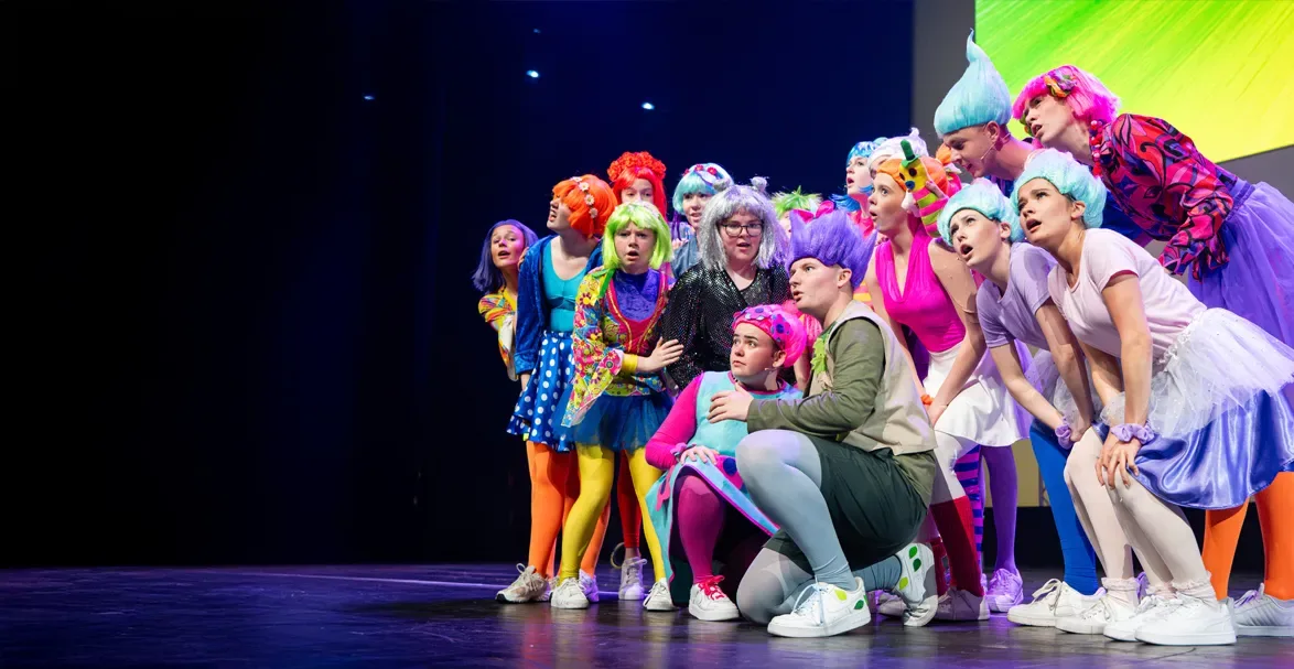 Cast of Trolls JR in huddle. 
